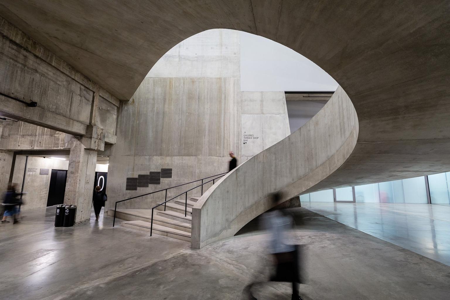 A huge concrete staircase spiralling to the floor above