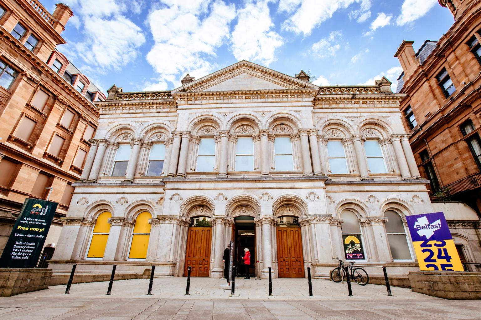 A Gothic Revival style two storey building with seven bays on each floor, with three large wooden doors in the centre.