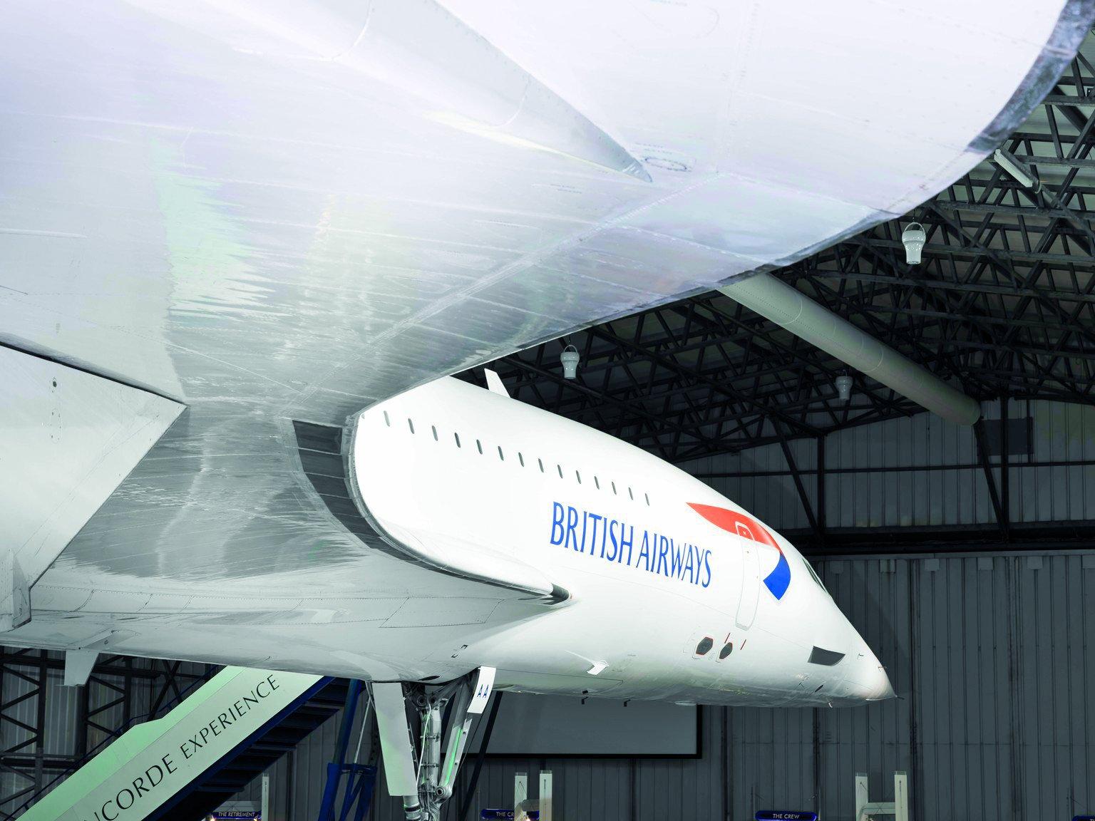 Under the wing of a British Airways concorde in an aircraft hangar
