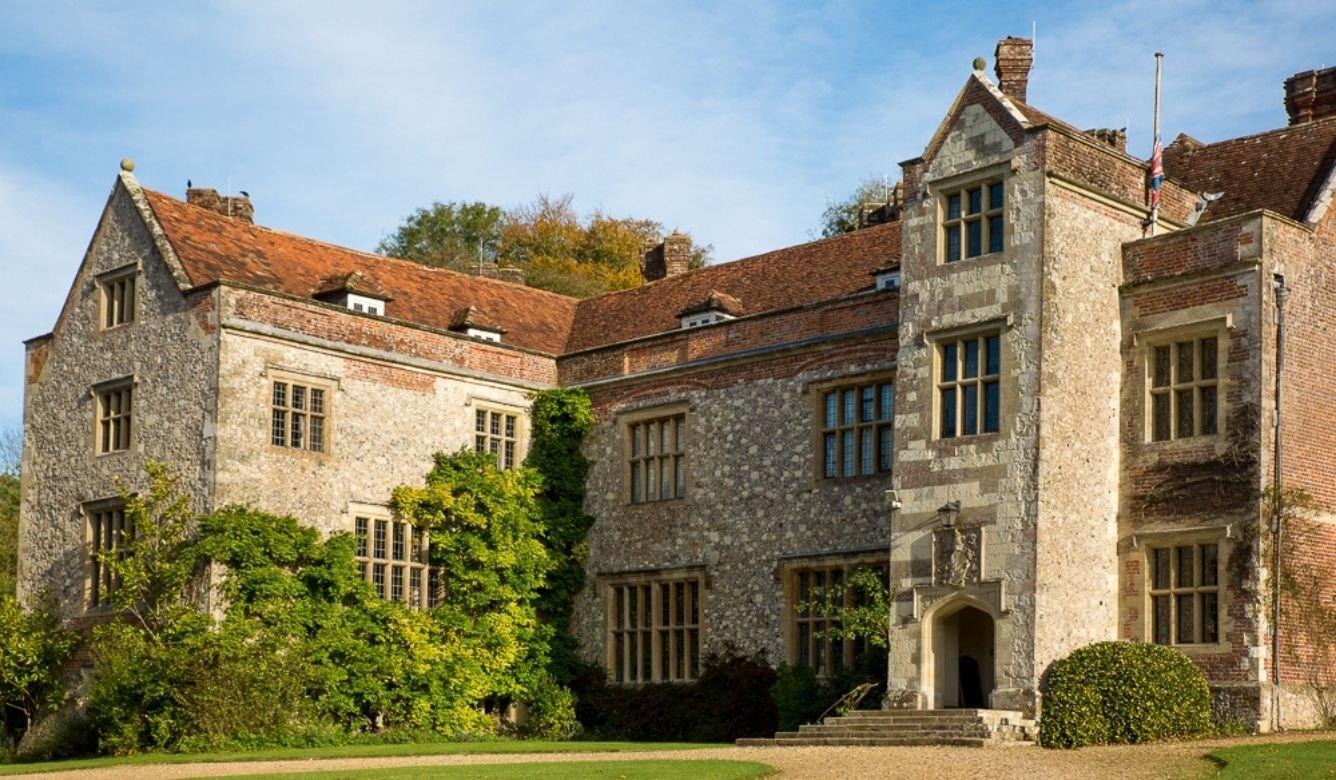 The exterior of an historic house with vines climbing the walls