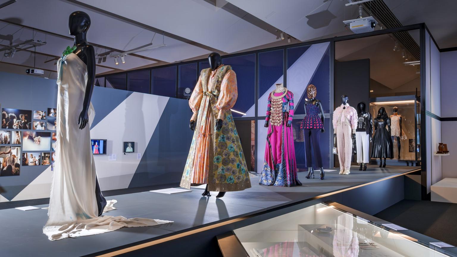 Mannequins on a runway display dressed in high-end fashion designs.