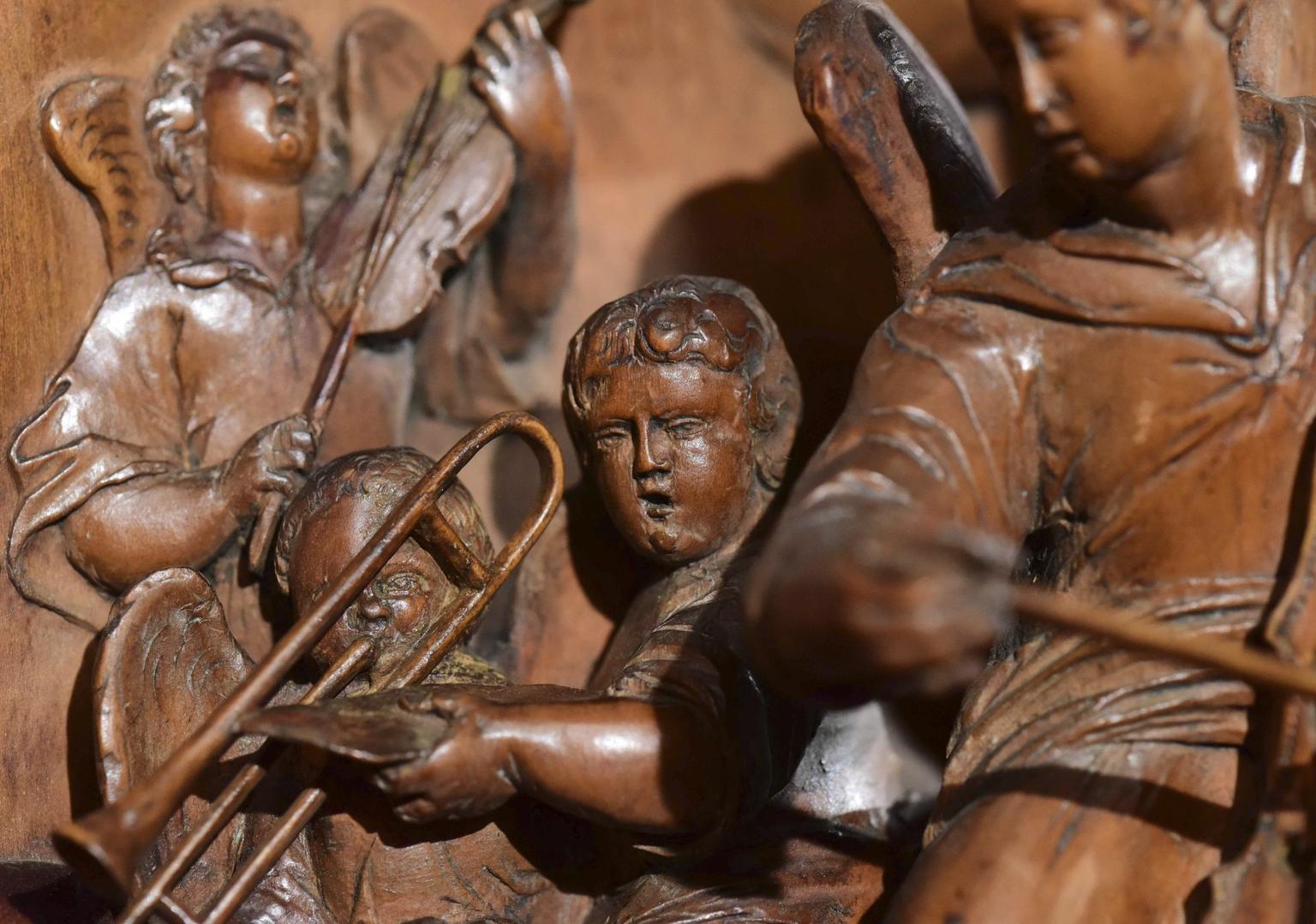 A remarkable and beautifully carved narrative high relief depicting a visionary concert led by King David, playing a harp, ringed by dancing cherubs and in the heavenly realms accompanied by angelic musicians and St Cecilia, the patron saint of music. Reflecting this master craftsman’s own love of music, the panel is a celebration of Psalms 148 and 150. Making the design even more special, the harp is incised with the armorials of the Barwick family.