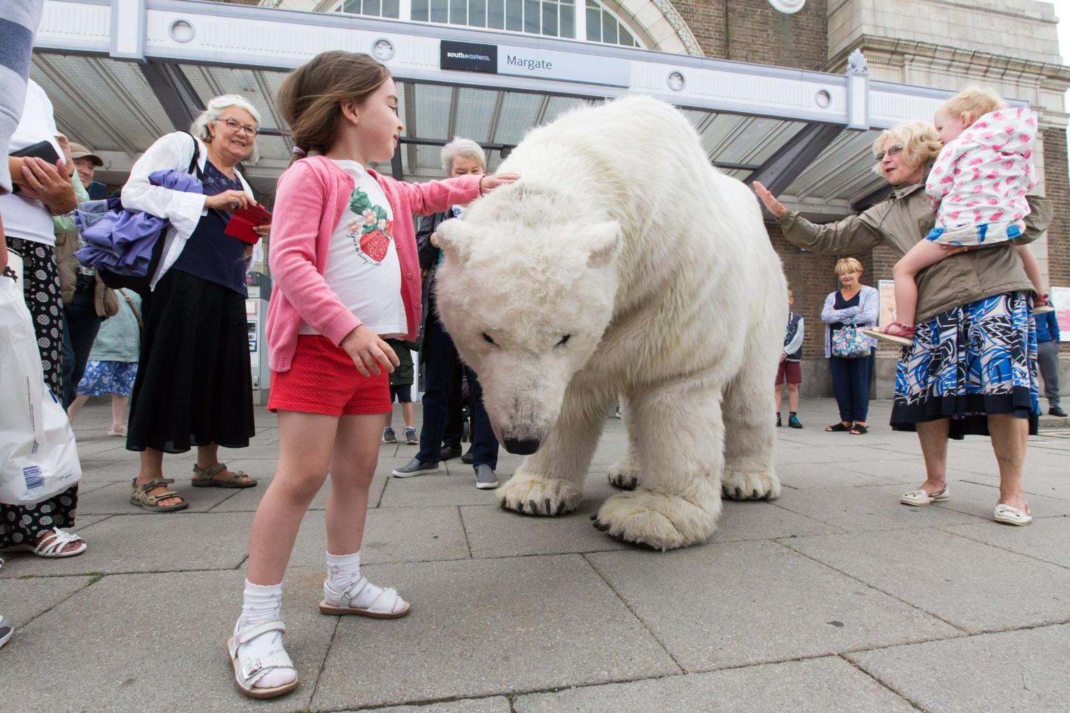 A young visitor pets Paula the Polar Bear outside Turner Contemporary