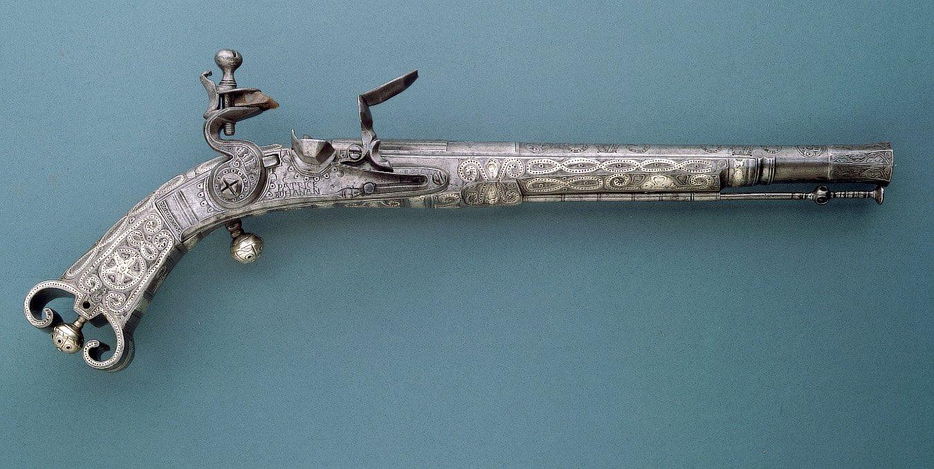 Silver pistol on a blue background