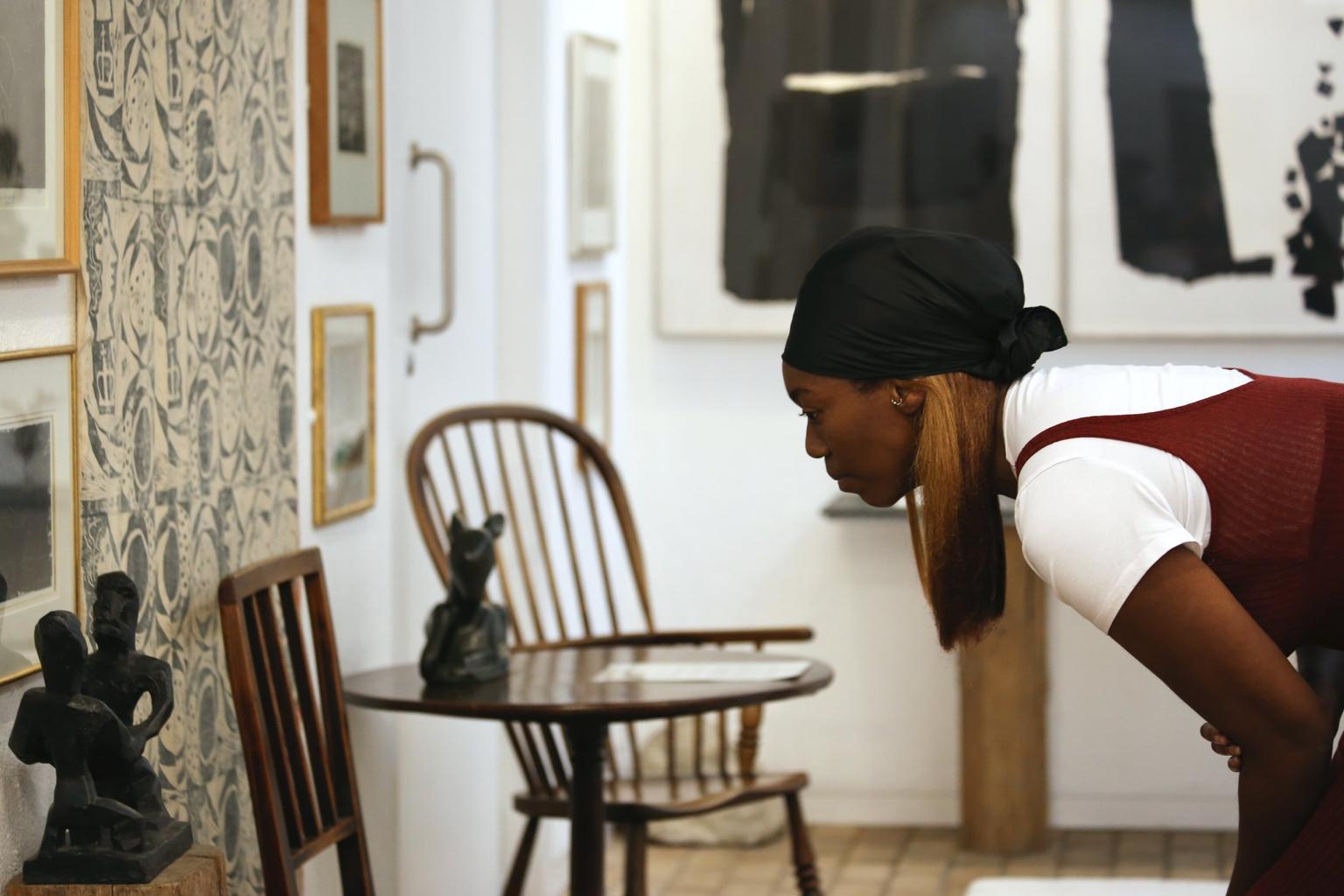 Visitor looking closely at a chair at Kettle's Yard, Cambridge