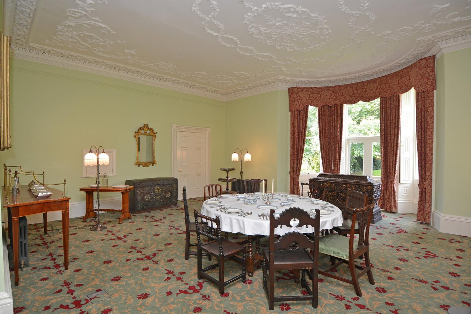 An ornate dining room with sculpted ceiling
