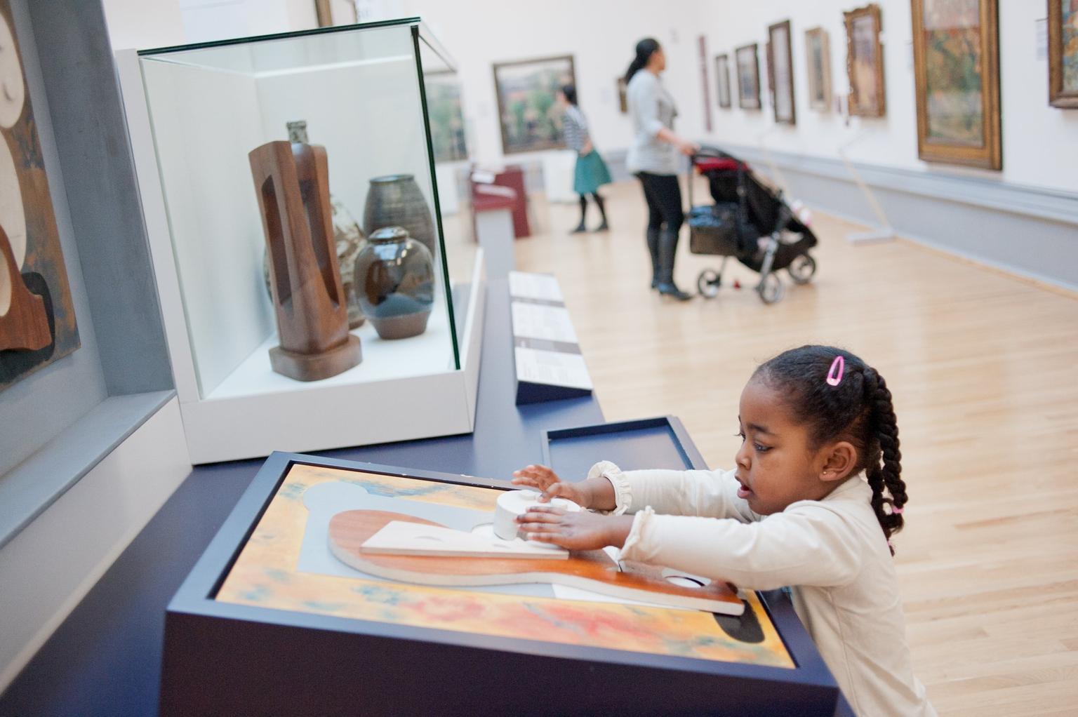 A young girl plays with a display in the family room