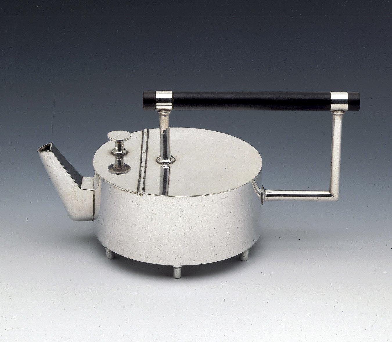 This rare and highly important small electroplated teapot was one of a small collection of unusual geometric examples, all originally made as samples or prototypes. Six of the teapots, including this one, never reached production, being considered too eccentric and advanced for the period. The unusual oriental design of the teapot can be largely attributed to Dresser's three-month visit to Japan at the end of 1876. The Japanese aesthetic influence is evident in the teapot's low, drum-shaped body, and simple angular spout, almost certainly based on the traditional Japanese sake bottle. The small hinged cover, placed at the front of the teapot, is suggestive of that on a Japanese portable writing set. It is Dresser's interpretation of the Japanese aesthetic, however, that make his designs so interesting.