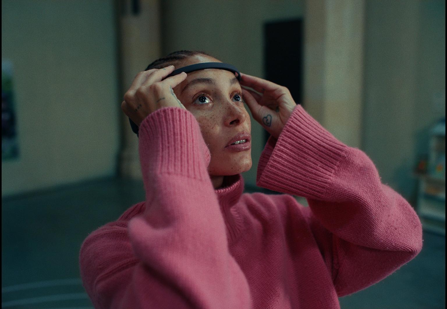 Adwoa Aboah wearing an EEG headset.