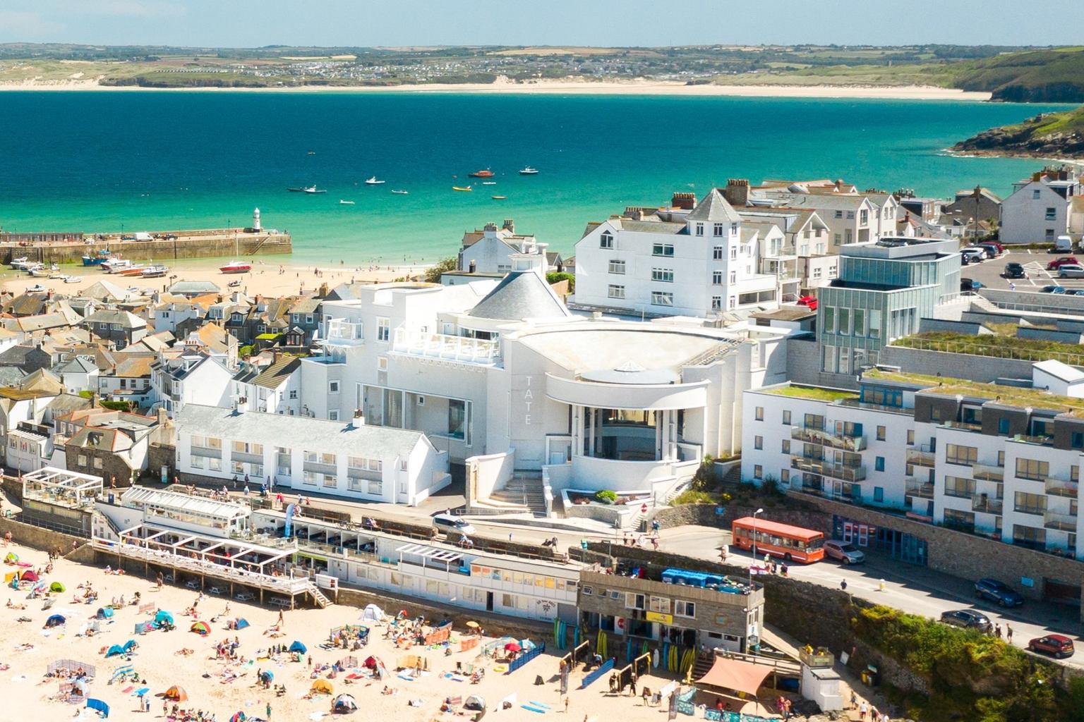 An aerial shot of Tate St Ives with beach in front and sea behind