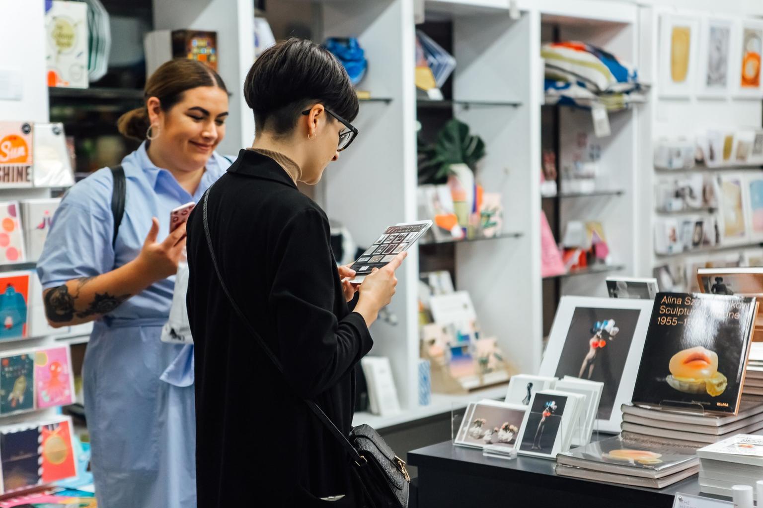 Two women looking at products in the Hepworth Wakefield Shop