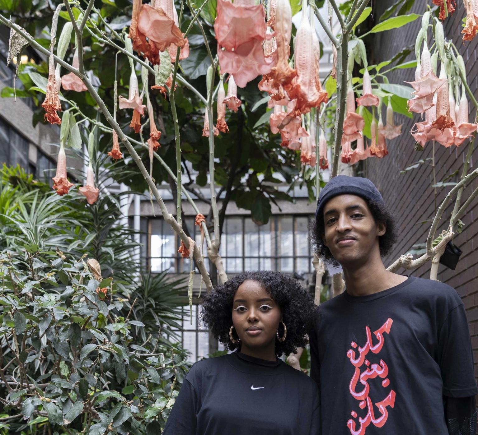 Two people stand in the garden room in the Barbican Centre