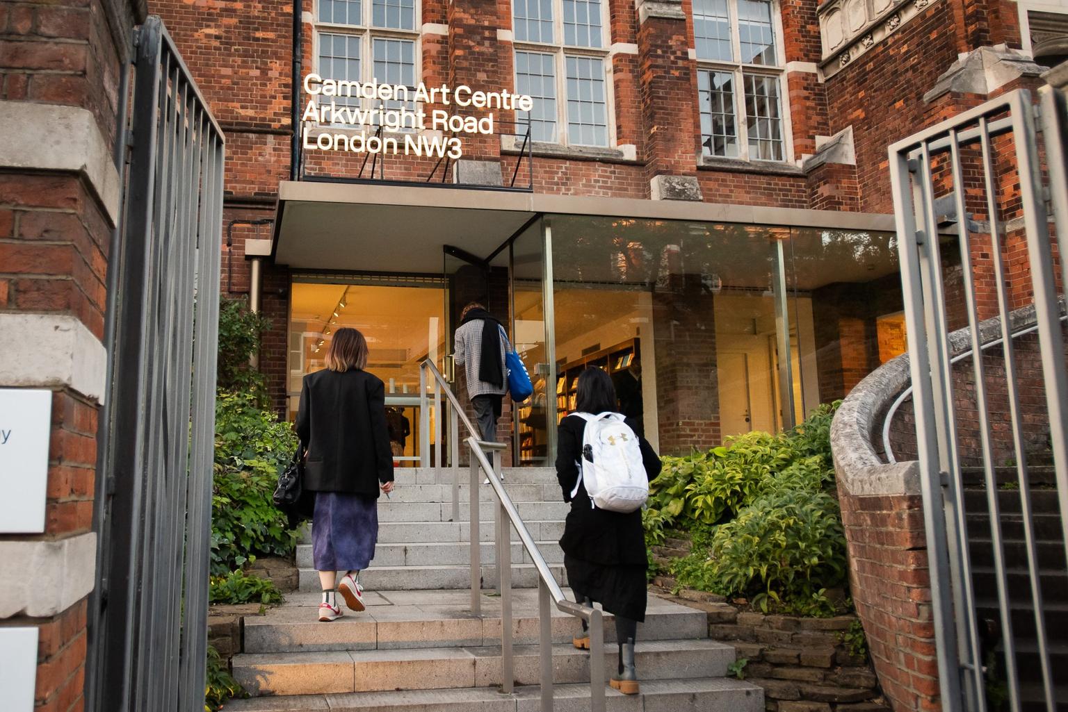 Three people climbing the steps to the entrance of Camden Art Centre