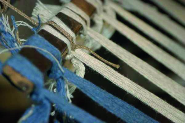 Threads knotted to a length of wood