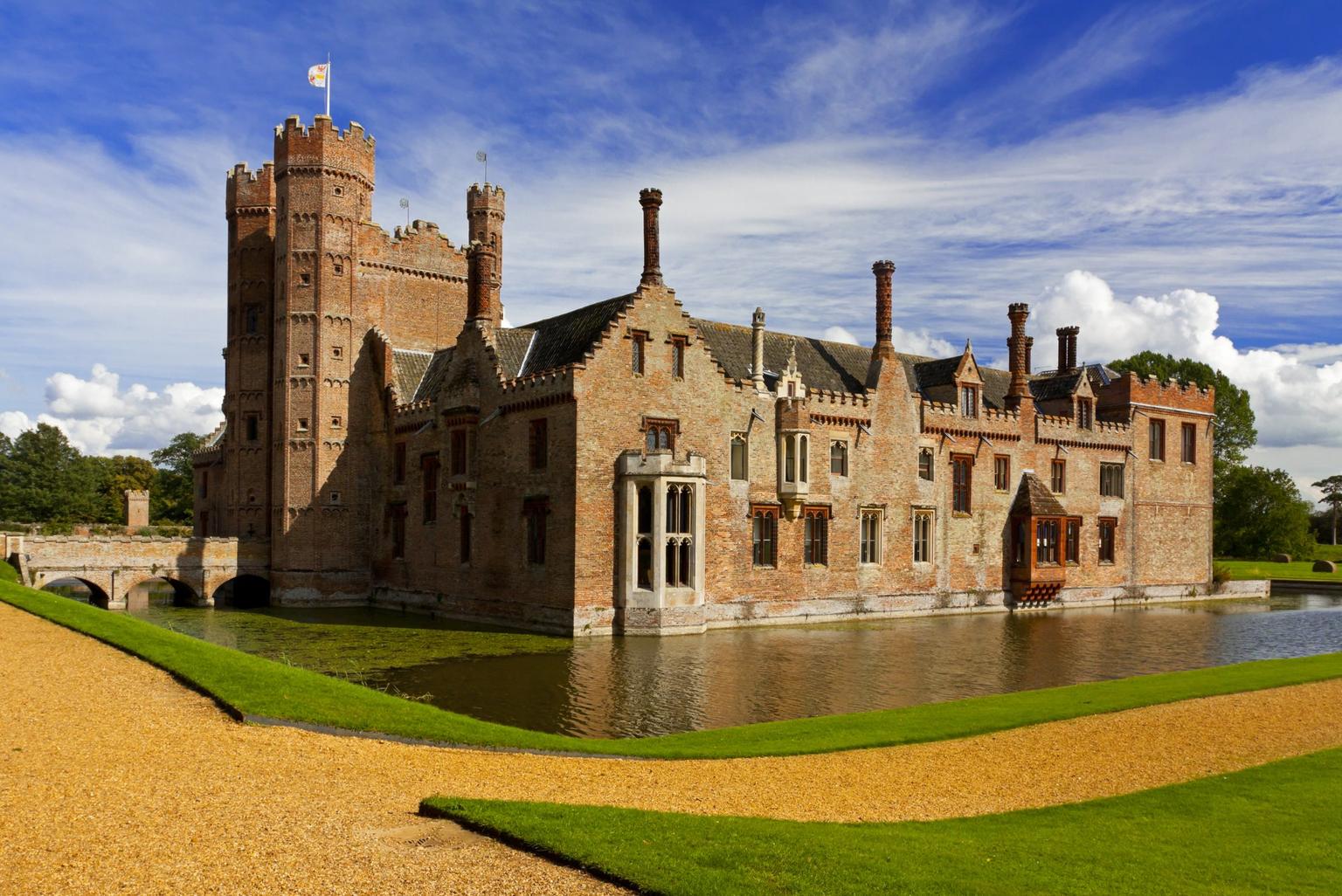 A grand house surrounded by a moat