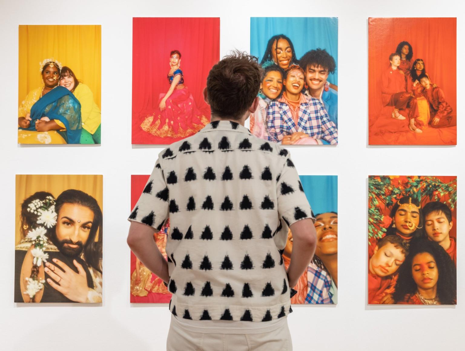 A person viewing a photography exhibition called ‘Queer Britain’