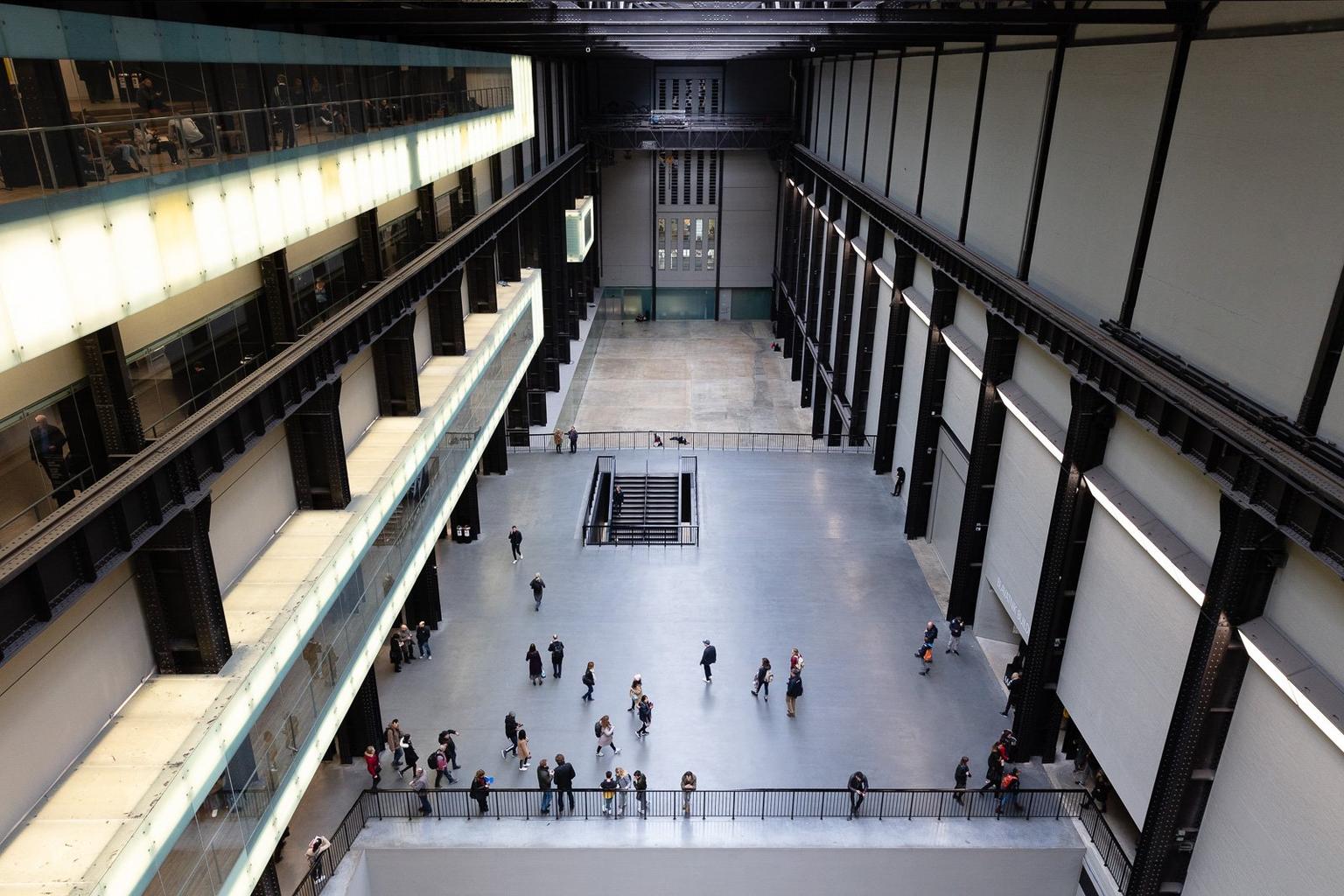 A view down onto the Turbine Hall Space with people on a central landing
