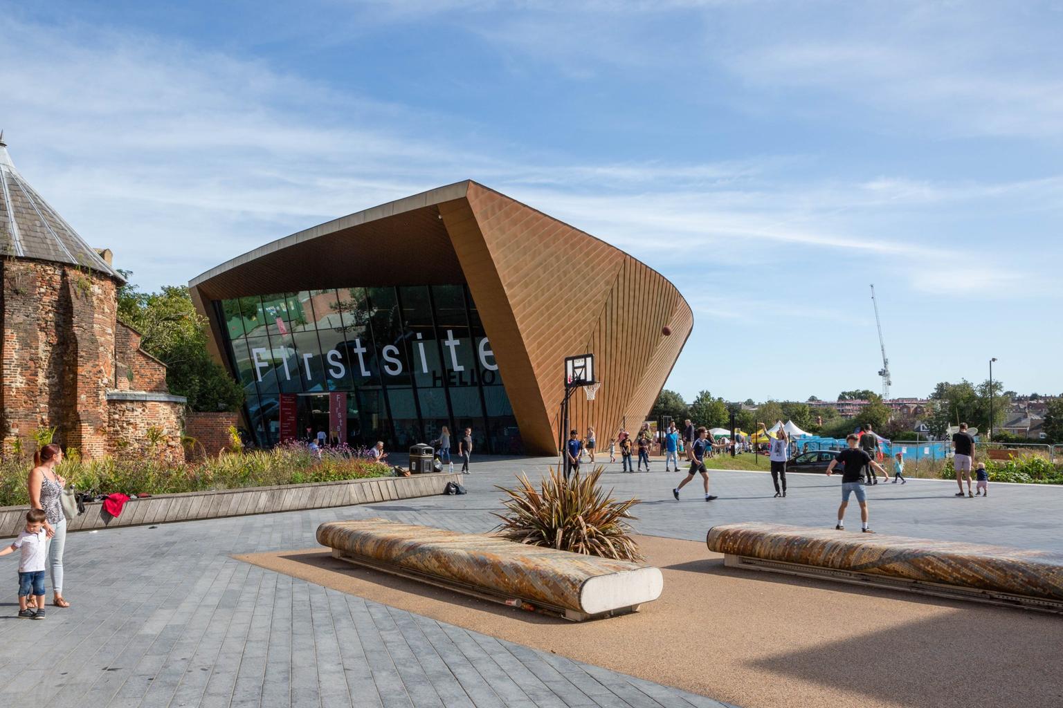 The copper clad exterior of Firstsite gallery, with people in the foreground