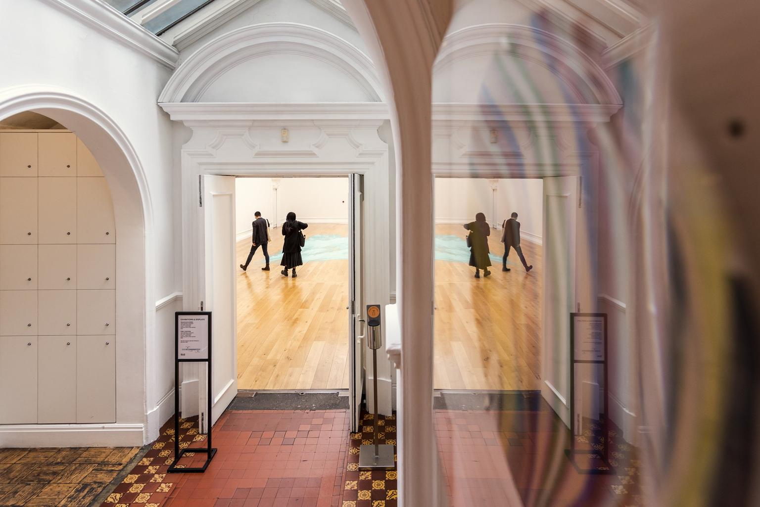 A door with a view in to a gallery beyond