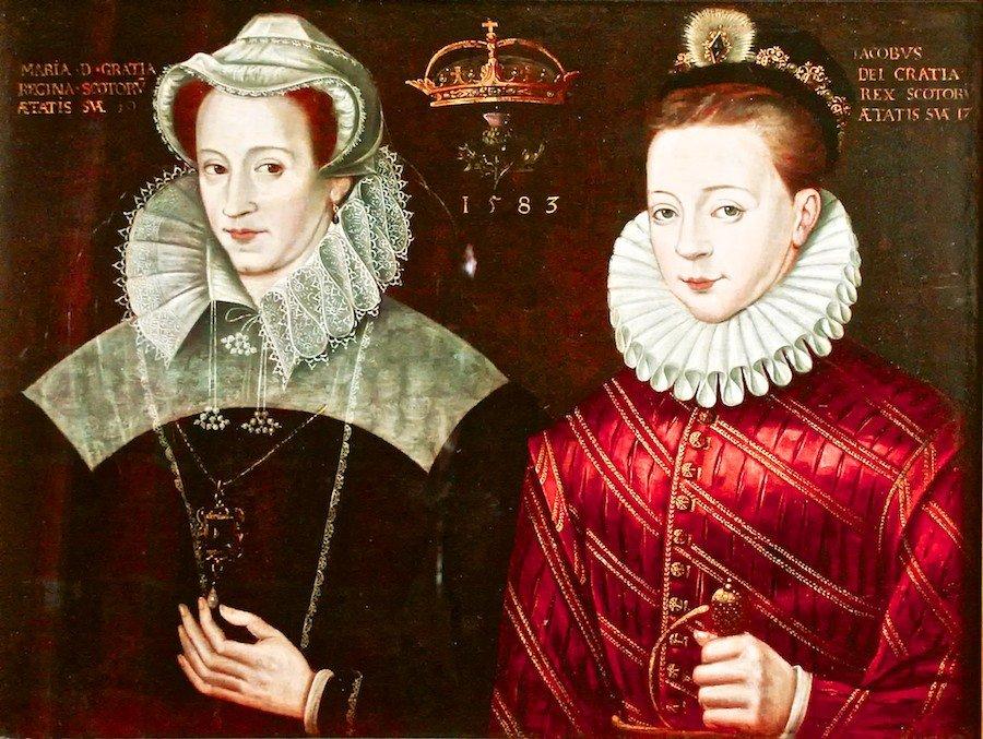 Oil portrait painting of King James in a silky red shirt with gold buttons and a white ruff and he looks directly at the viewer. To his right is Mary Queen of Scots, wearing a black dress with white shoulders, a white ruff, a white hat and a pearl necklace, which she is touching. Her gaze is directed at James.