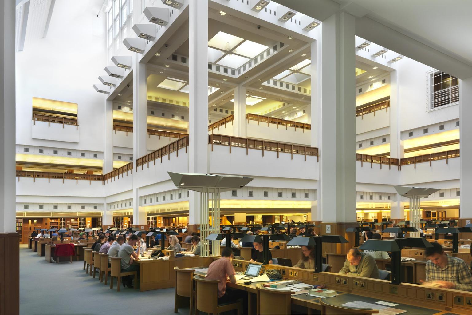 Ground floor desks with balcony levels visible behind tall pillars
