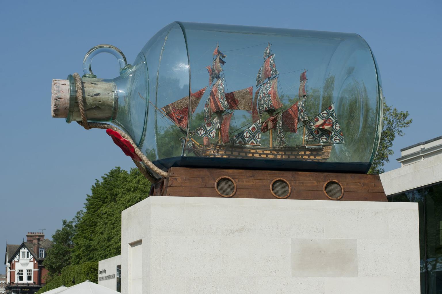 The Art Fund and National Maritime Museum launched a successful public appeal to acquire and permanently display this work outside the new Sammy Ofer Wing of the museum, where it is clearly visible across Greenwich Park. Alongside the Art Fund's grant of £50,000, £251,677 was raised through the public campaign, mostly from individuals. The work is a scaled-down replica of HMS Victory, the ship captained by Nelson. It was commissioned by the Greater London Authority in 2009 for the fourth plinth in Trafalgar Square, where it was displayed from May 2010 to January 2012. The only significant departure from the historical Victory is the use of richly patterned 'Dutch Wax' fabric (a trademark of the artist's work) for the 37 sails. The fabric is commonly associated with African dress and symbolic of African identity and independence. Tying together historical and global threads, the work considers the legacy of British colonialism and its expansion in trade and Empire, made possible through