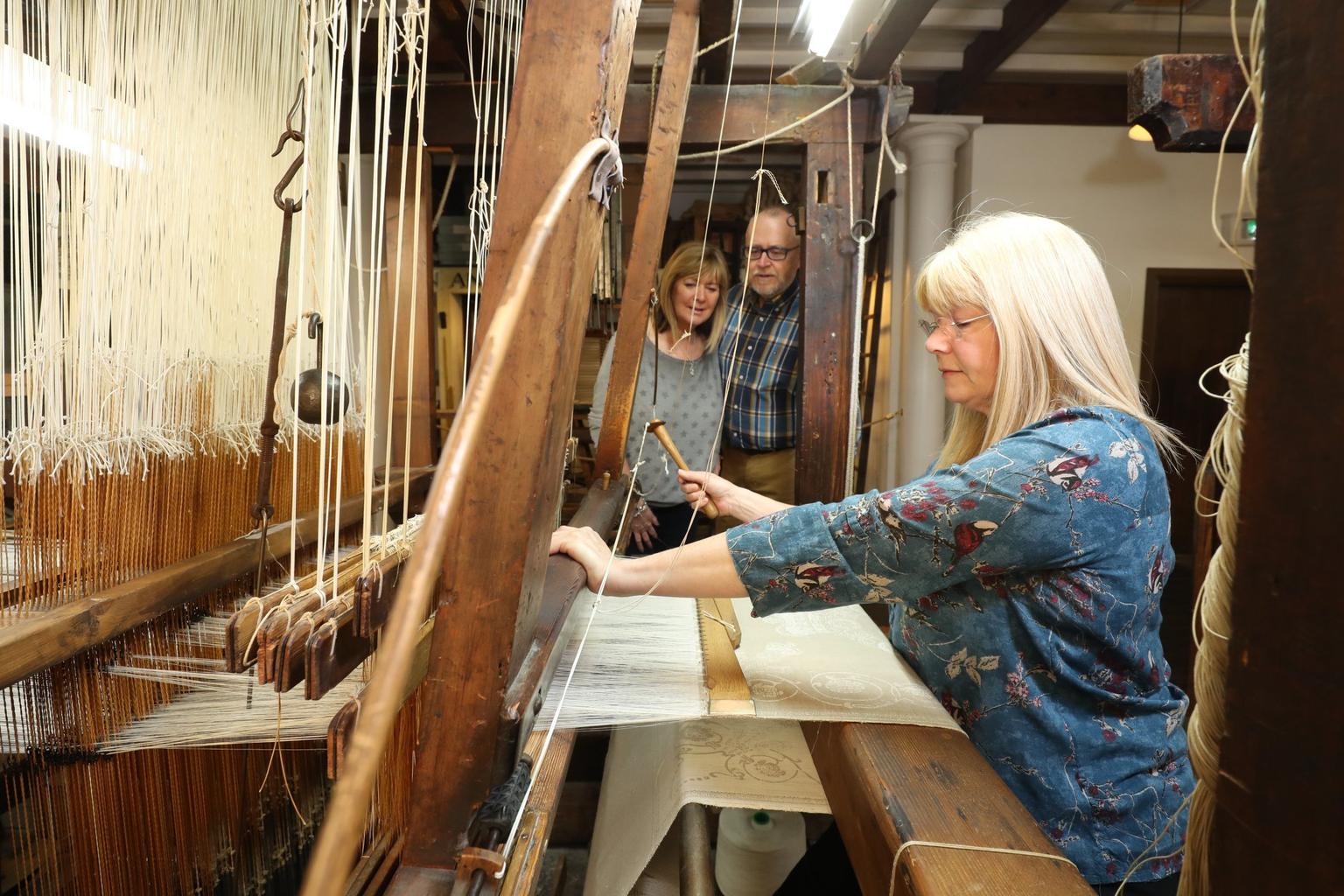 Visitor weaving on a 170-year-old Irish linen damask handloom