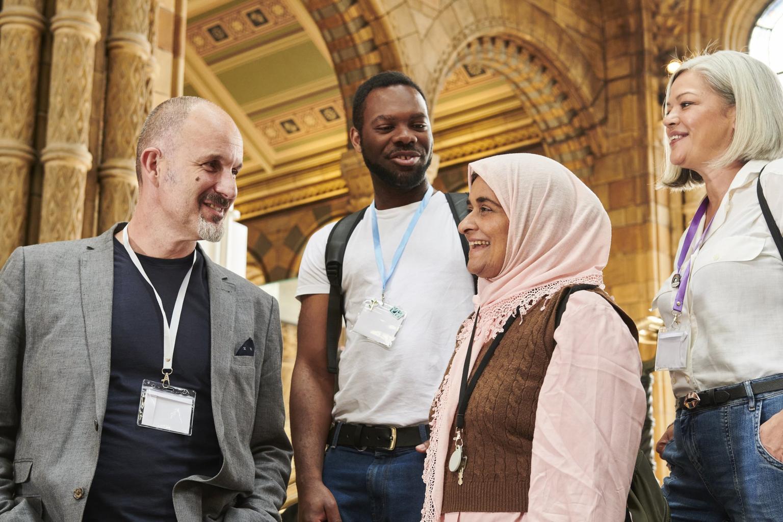 Four teachers stand talking in a museum