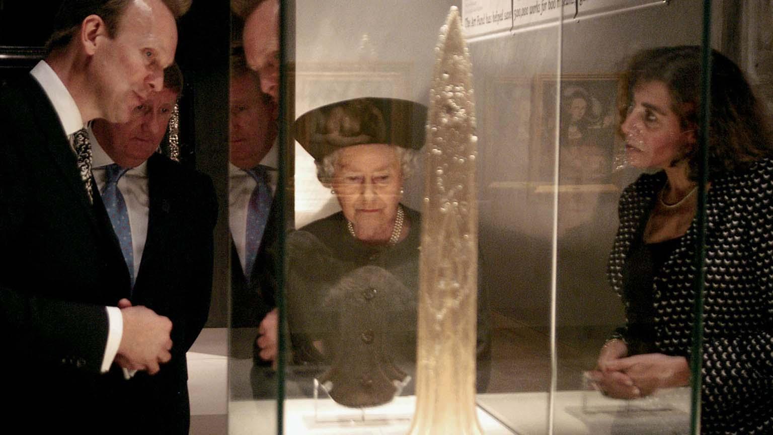 Her Majesty The Queen, with David Barrie and Brian Allen, admiring the Oxborough Dirk, on loan from the British Museum, at the Royal opening of 'Saved!', Hayward Gallery, 2003.